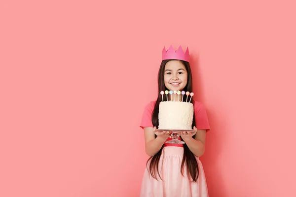 Cute little girl with Birthday cake on color background