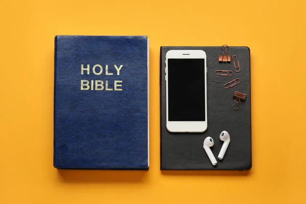 Holy Bible Mobile Phone Earphones Color Background — Stock Photo, Image