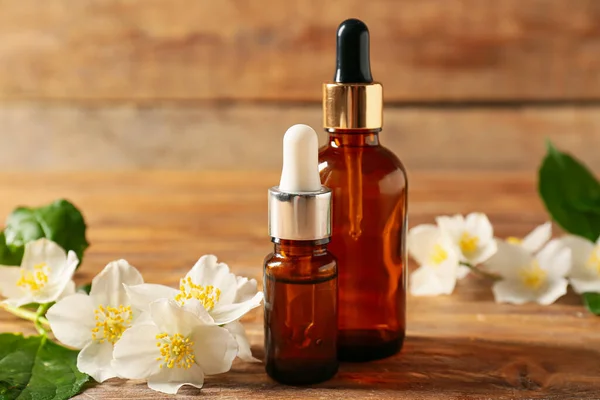 Bottles Essential Oil Jasmine Flowers Wooden Background — Stock Photo, Image
