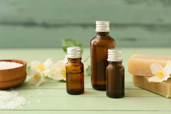 Bottles Essential Oil Sea Salt Soap Jasmine Flowers Color Wooden — Stock Photo, Image