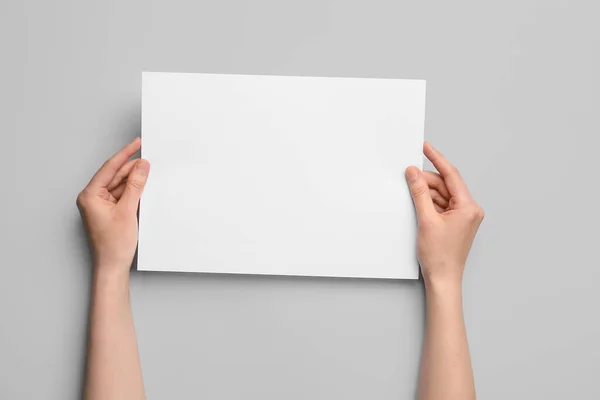 Woman Holding Blank Sheet Paper Grey Background — Stock Photo, Image