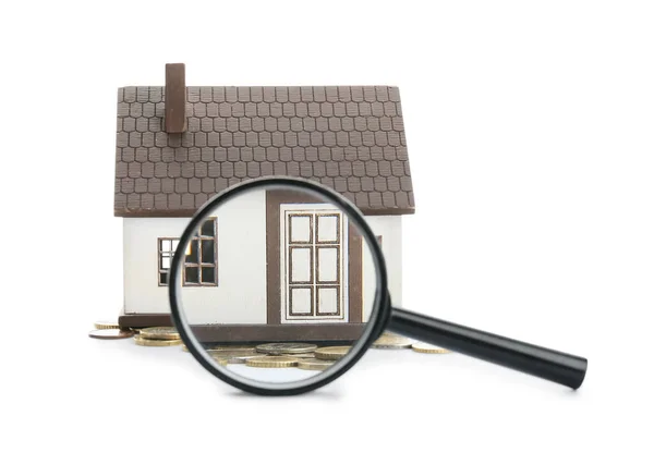 stock image Figure of house, magnifier and money on white background. Concept of buying real estate