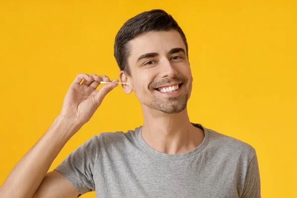 Young Man Cleaning Ears Cotton Bud Color Background — Stock Photo, Image
