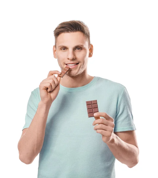 Handsome Young Man Eating Tasty Chocolate White Background — Stock Photo, Image