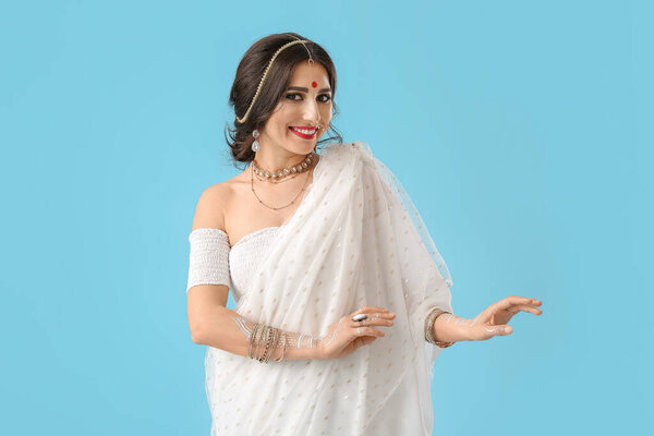 Beautiful Indian woman on color background