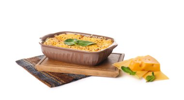 Lezzetli yeşil lazanyalı fırın yemeği ve beyaz arka planda malzemeler.