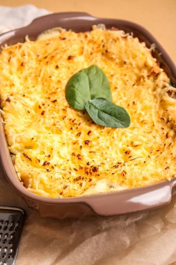 Renkli arka planda lezzetli yeşil lazanyalı fırın yemeği, yakın plan.