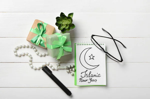 Festive composition for Islamic New Year on white wooden background