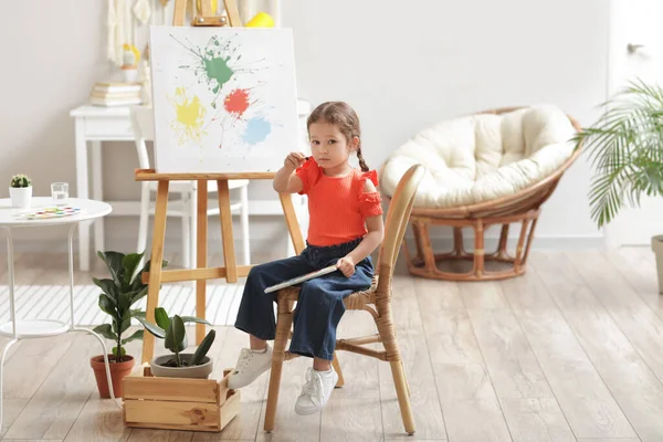 Cute little artist painting at home