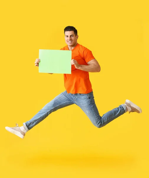 Young Man Blank Paper Sheet Jumping Color Background — Stock Photo, Image