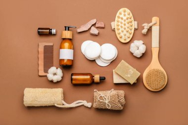 Renk arkaplanında pamuk pedleri, tarak, fırça ve kozmetik ürünleri ile kompozisyon