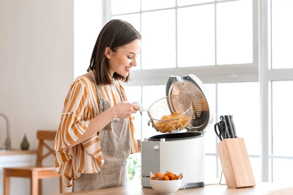 Young Woman Taking Tasty French Fries Deep Fryer Kitchen — Stock Photo, Image
