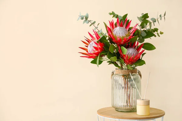 Renk Duvarının Yanında Protea Çiçekleri Olan Masa — Stok fotoğraf