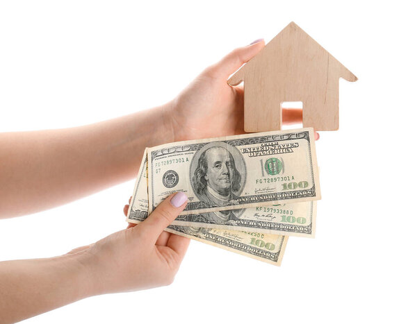 Hands with figure of house and money on white background. Concept of buying real estate