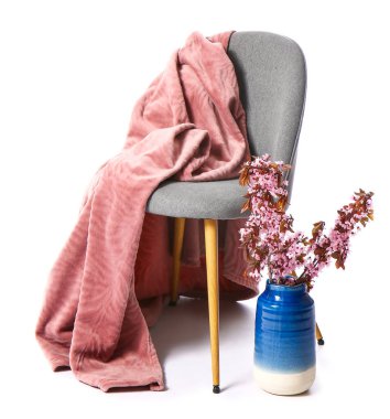 Chair, plaid and vase with blooming branches on white background
