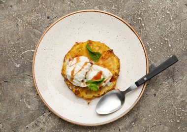 Plate with grilled pineapple slice and ice cream on grunge background