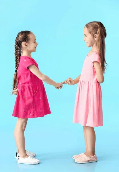 Cute Little Sisters Making Pinky Promise Color Background — Foto Stock