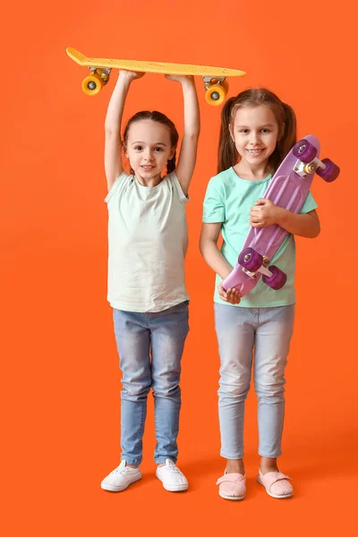 Cute Little Sisters Skateboards Color Background — Stock Photo, Image