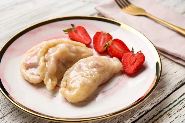 Plate Tasty Strawberry Dumplings Light Wooden Background Closeup — Φωτογραφία Αρχείου