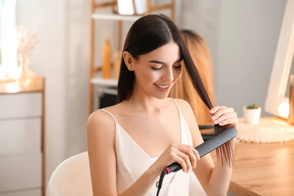 Beautiful Young Woman Straightening Hair Home — Stock Photo, Image