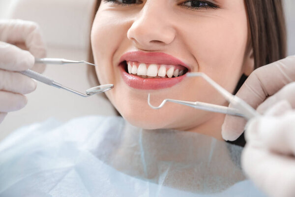 Young woman visiting dentist in clinic, closeup
