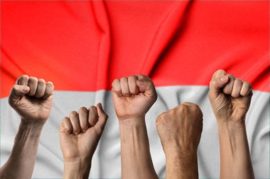 Endonezya bayrağına karşı yumruklarını sıkmış birçok el