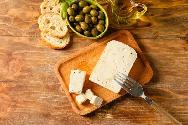 Board Tasty Feta Cheese Oil Olives Bread Wooden Background — Stock Photo, Image