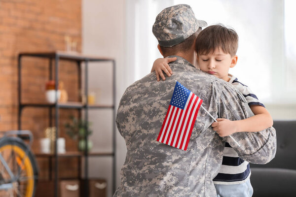 Soldier and his little son hugging at home. Memorial Day celebration