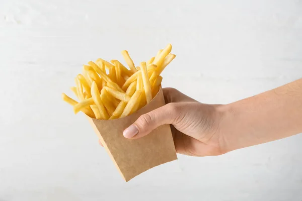 Female Hand Tasty French Fries Paper Bag Light Background — Stock Photo, Image