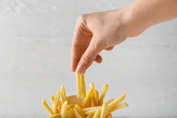 Woman Eating Tasty French Fries Light Background Closeup — Stock Photo, Image