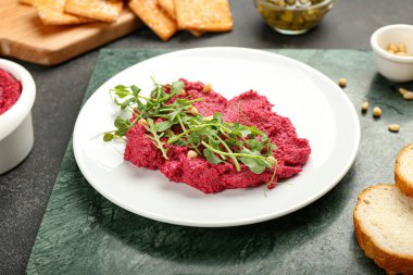 Lezzetli pancar humusu ve koyu arkaplanda taze lahanalar.