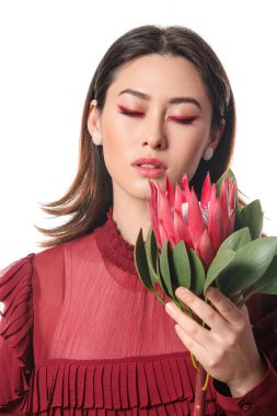 Beyaz arka planda protea çiçeği olan güzel genç bir kadın.