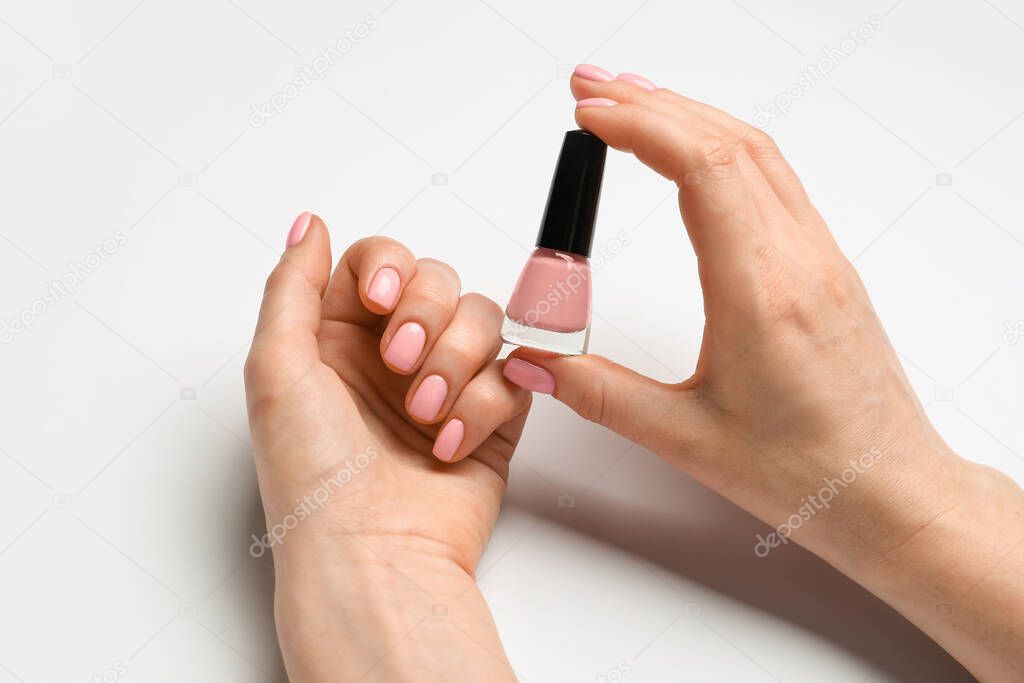 Hands with beautiful manicure and nail polish on white background