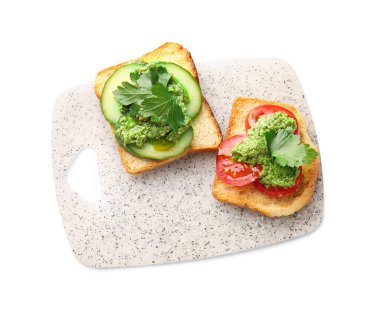 Beyaz arka planda pesto soslu lezzetli tostlar.