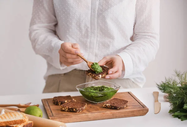 Woman Making Tasty Toasts Pesto Sauce Table Kitchen — Stock Photo, Image