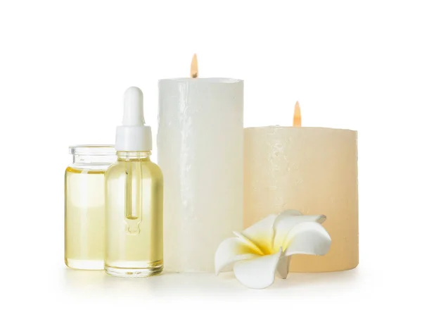 Composition Burning Candles Bottles Essential Oil Plumeria Flower White Background — Stock Photo, Image