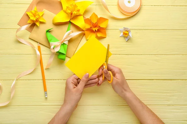 Woman Making Origami Narcissus Color Wooden Background — Stock Photo, Image