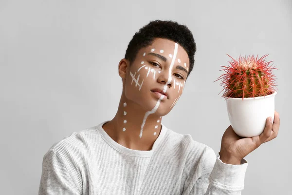 Young African American Guy Paint Face Cactus Light Background — Stock Photo, Image