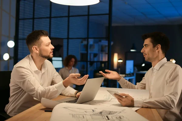 Business people working in office at night