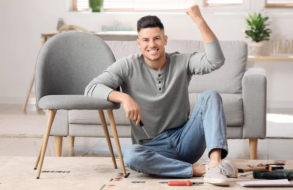 Happy Young Man Assembling Furniture Home — Stock Photo, Image