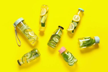 Arka planda salatalıklı limonata şişeleri