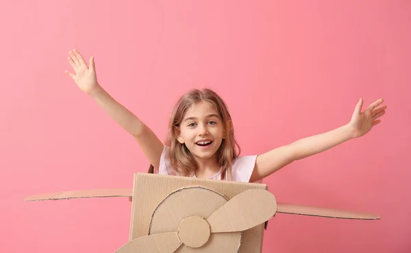 Little Girl Playing Cardboard Airplane Color Background — Stock Photo, Image