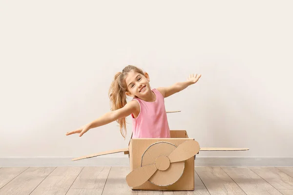 Little Girl Playing Cardboard Airplane Light Wall — Stock Photo, Image