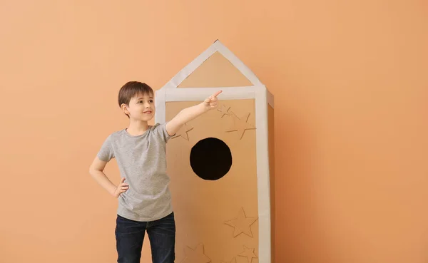 Cute Little Boy Cardboard Rocket Pointing Something Color Background — Stock Photo, Image