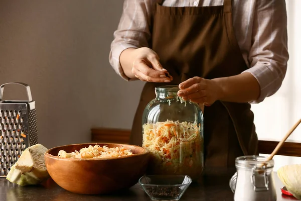 Woman Putting Tasty Sauerkraut Glass Jar Table Kitchen Closeup — Stock Photo, Image