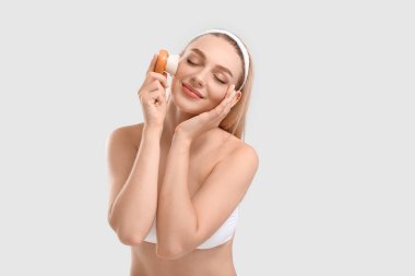 Masaj fırçası açık arkaplanda güzel bir genç kadın.