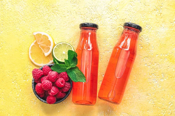 Flaskor Med Välsmakande Lemonad Och Skål Med Hallon Färg Bakgrund — Stockfoto