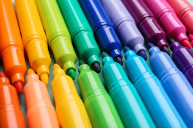 Set of markers on color background, closeup