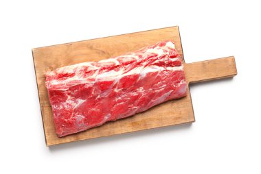 Wooden board with raw beef brisket on white background