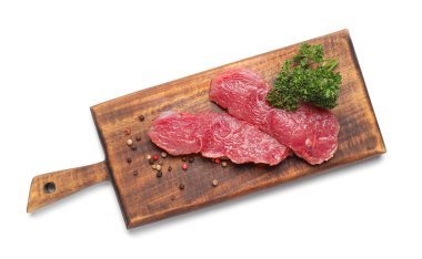 Wooden board with raw beef meat on white background